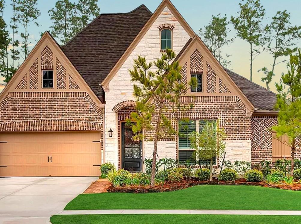 a front view of a house with a garden and plants