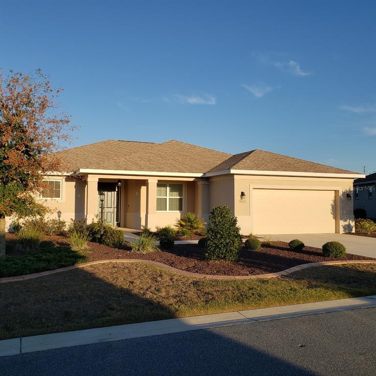 a view of house with yard and lake view