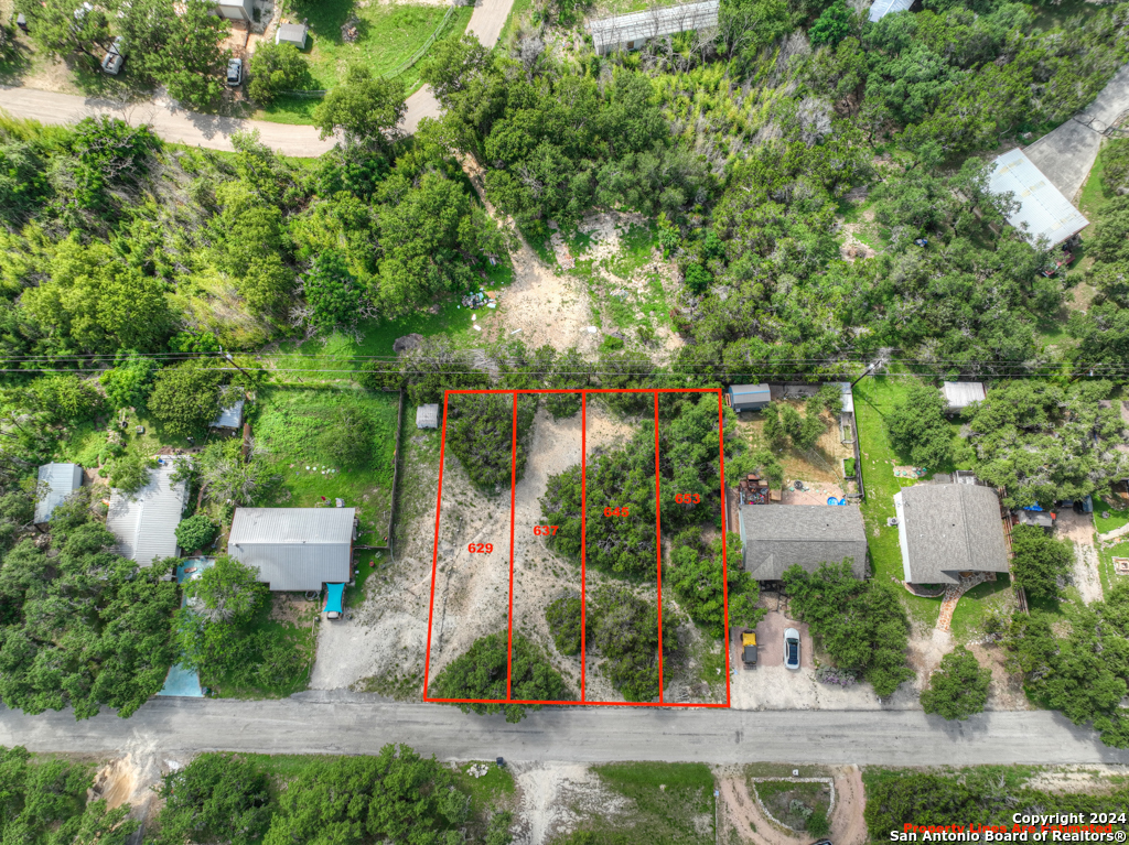 an aerial view of a house with a yard and fountain