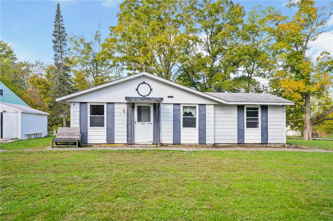 Single story home featuring a front lawn