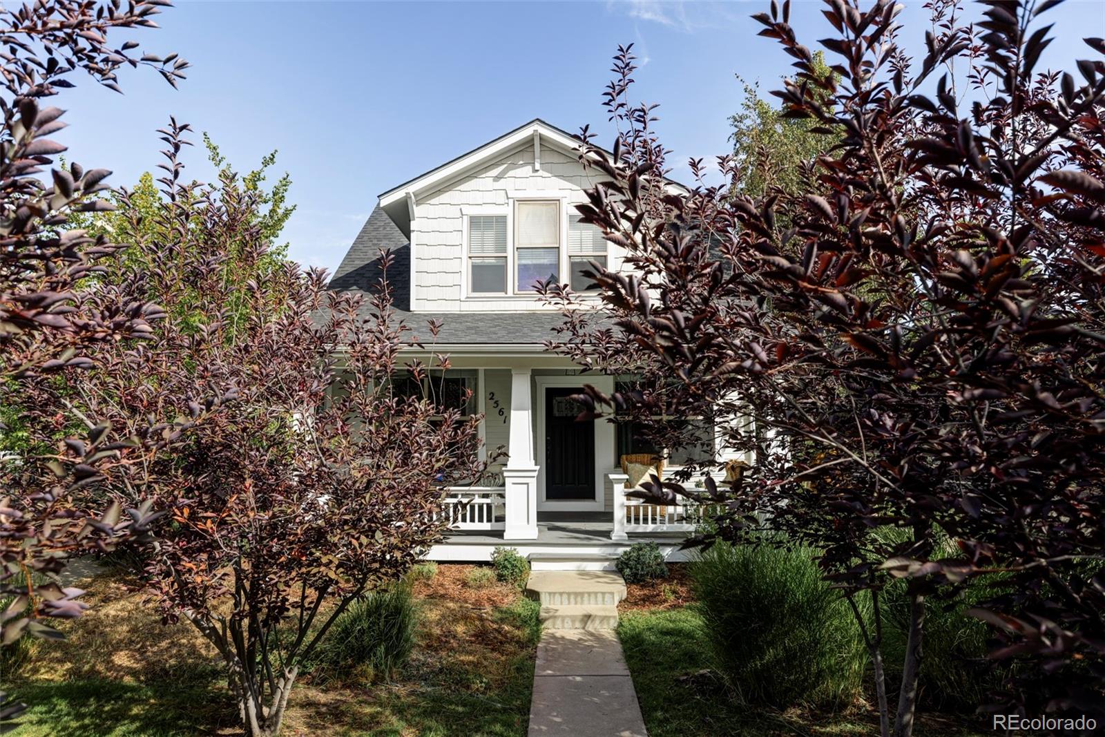 a front view of a house with yard and green space