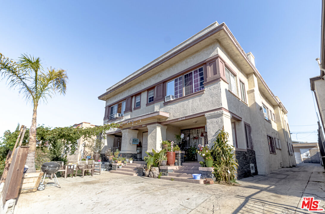 a front view of a building with sitting area