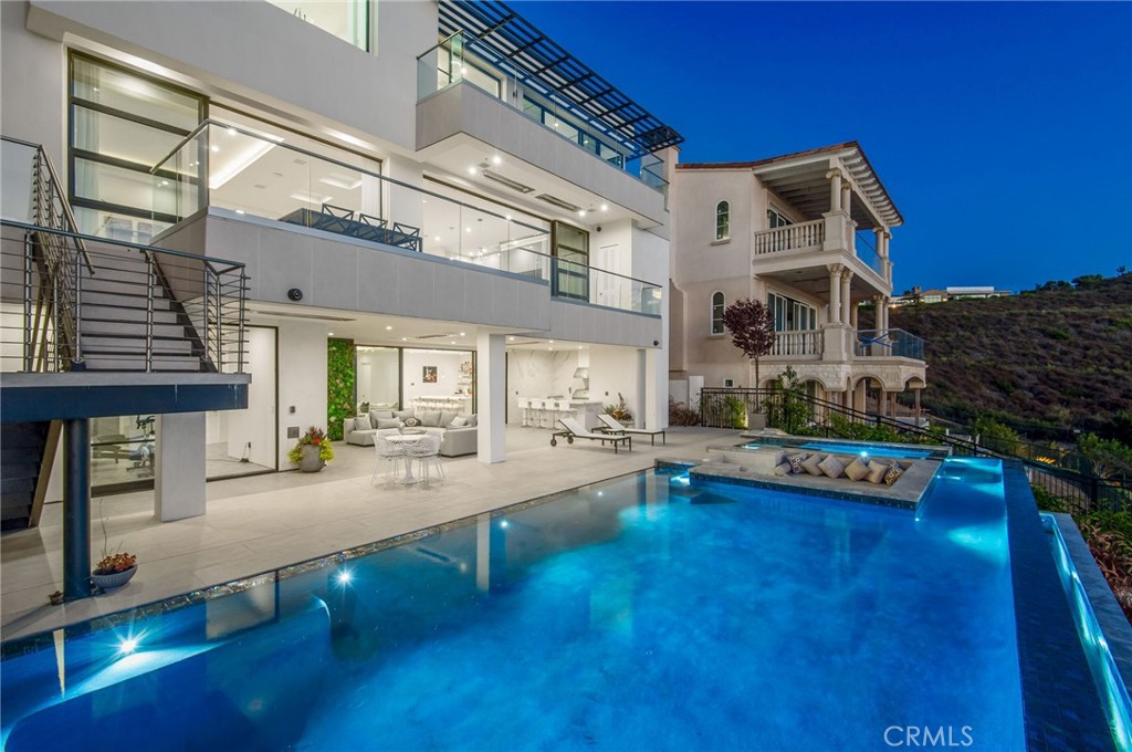 a view of a house with swimming pool and sitting area