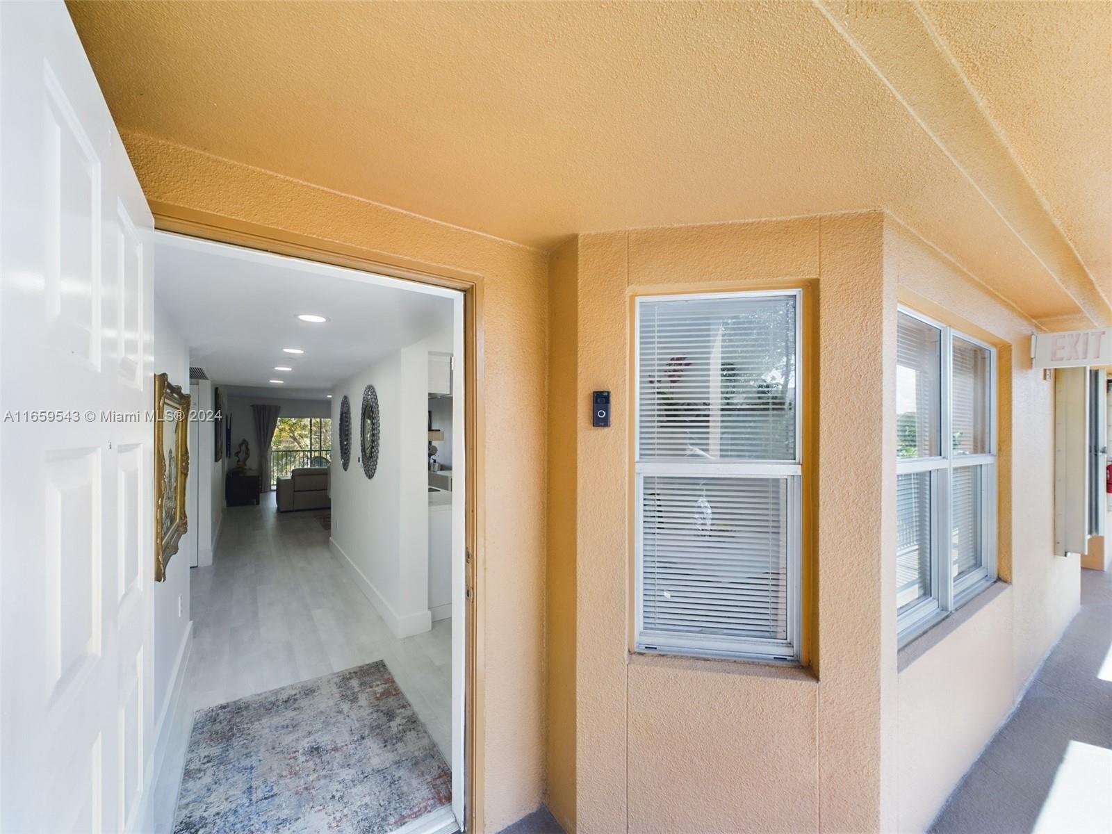 a view of a hallway view with wooden floor and windows