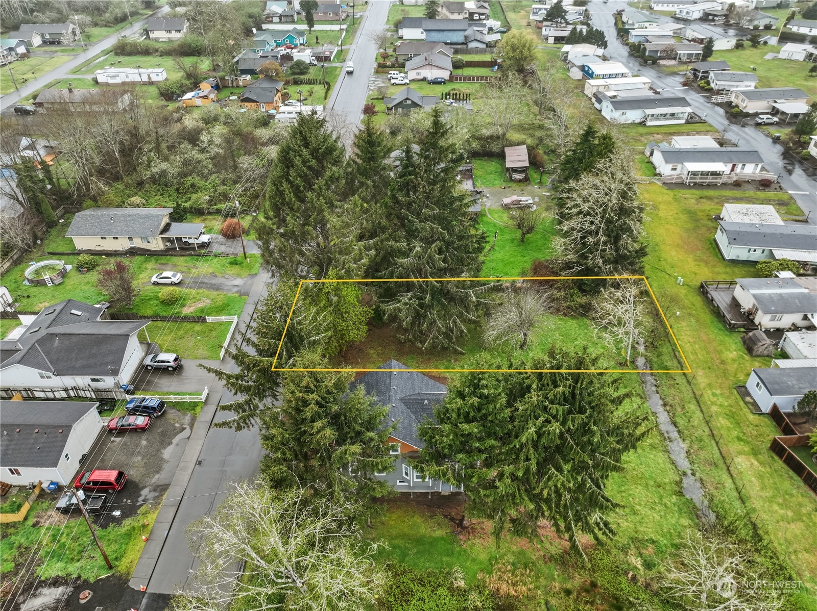 an aerial view of residential houses with outdoor space