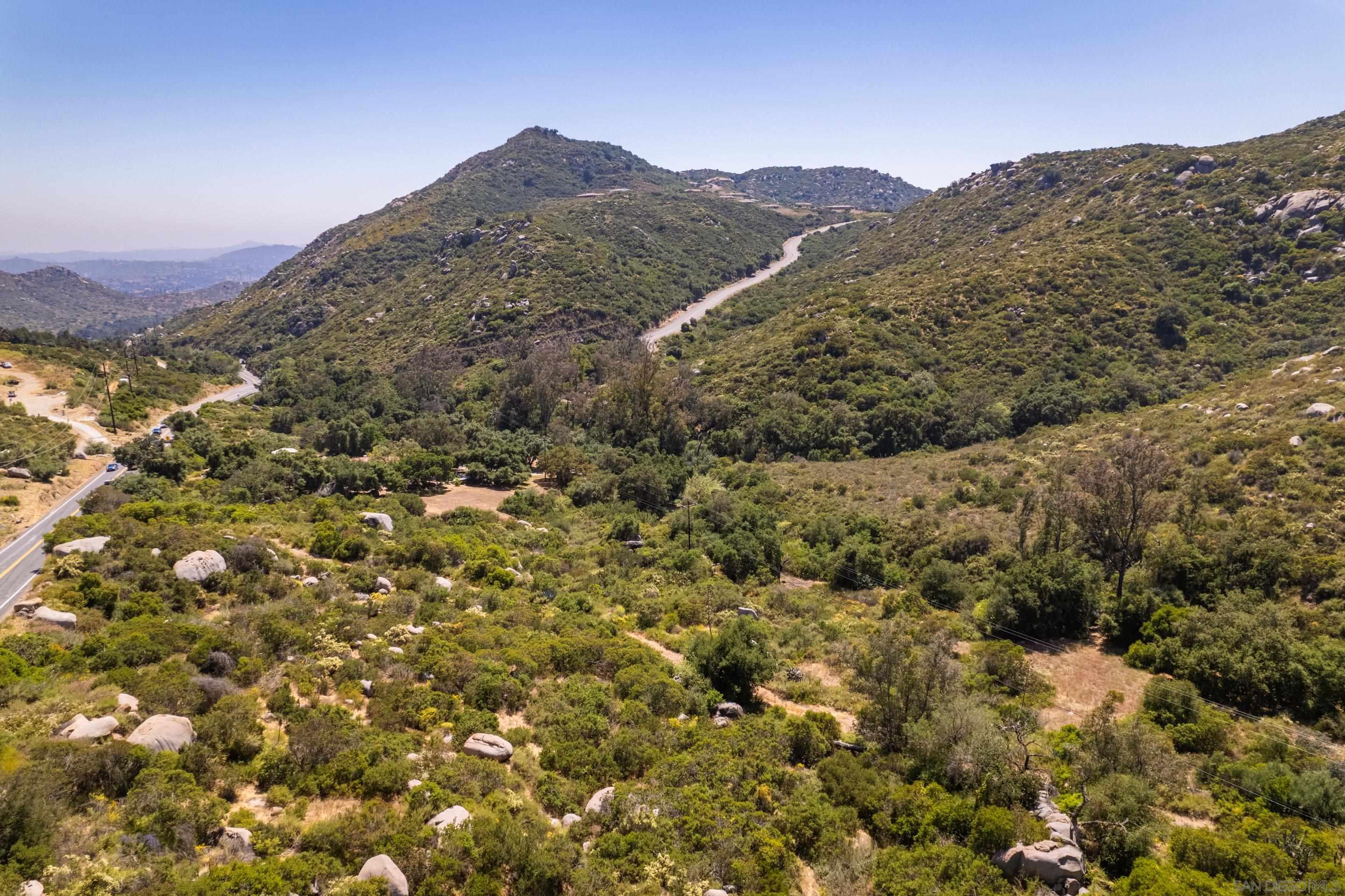 a view of a mountain range with trees in the background