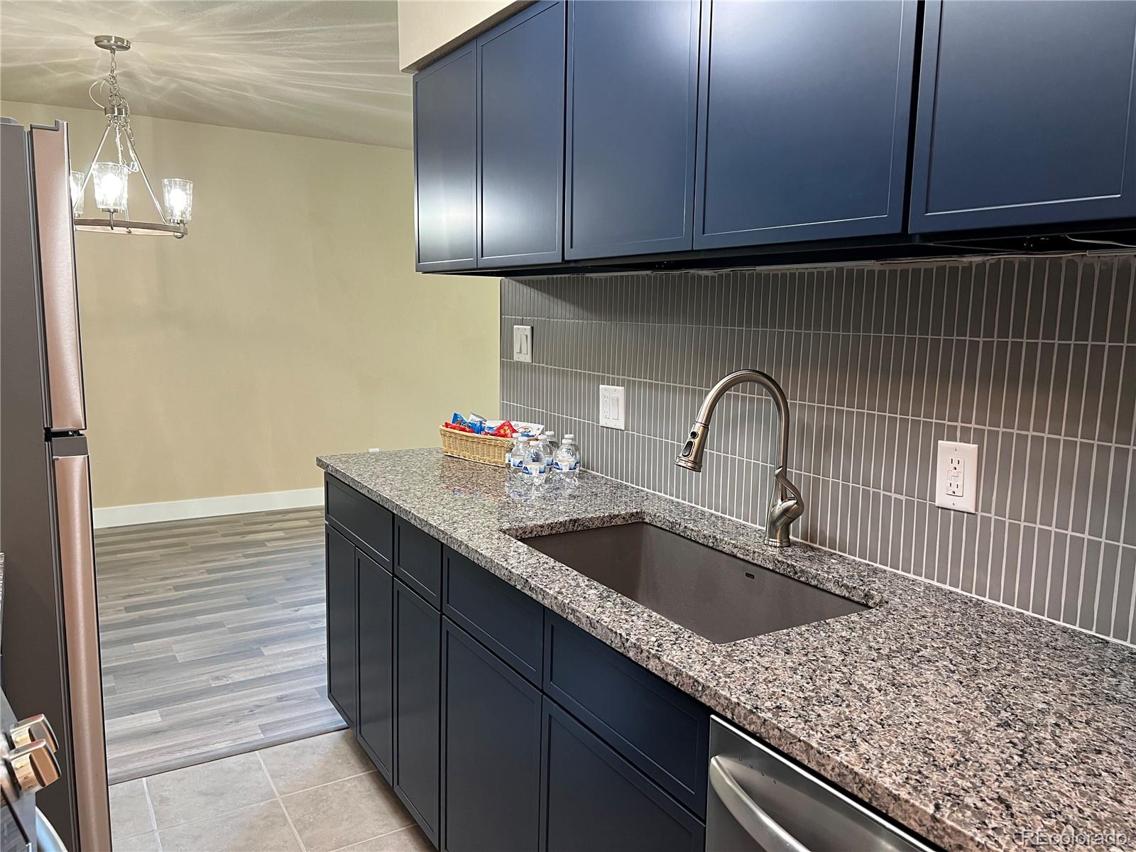 a kitchen with granite countertop stainless steel appliances sink and cabinets