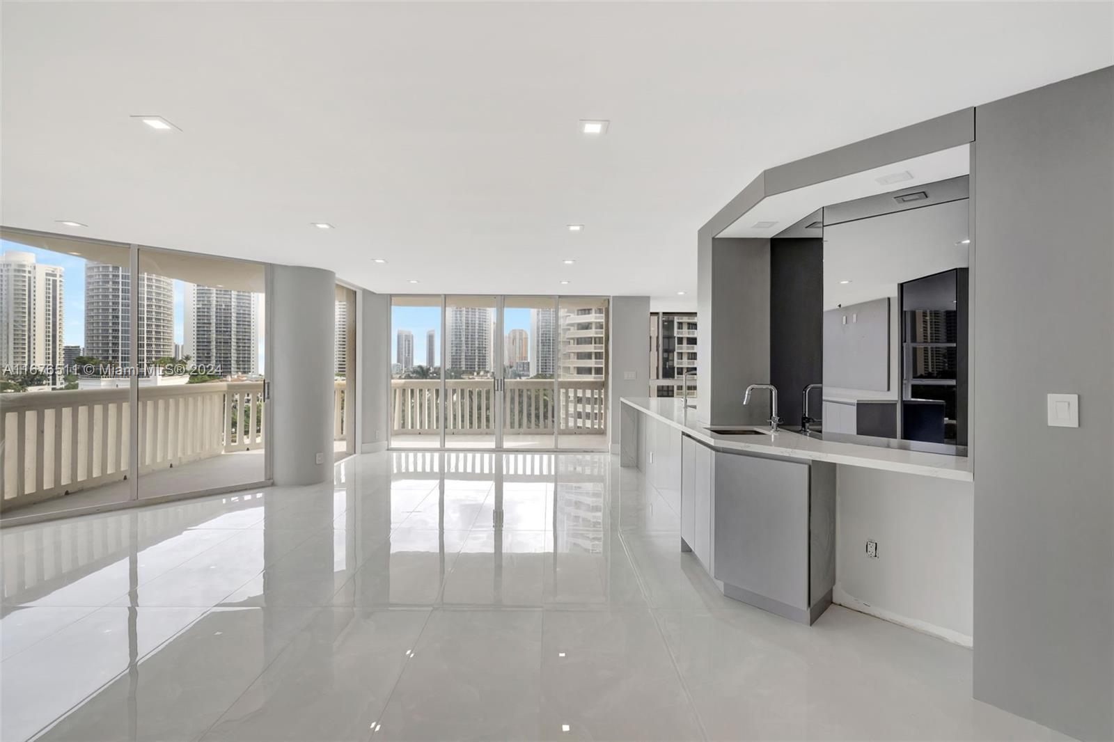 a view of a kitchen with large windows