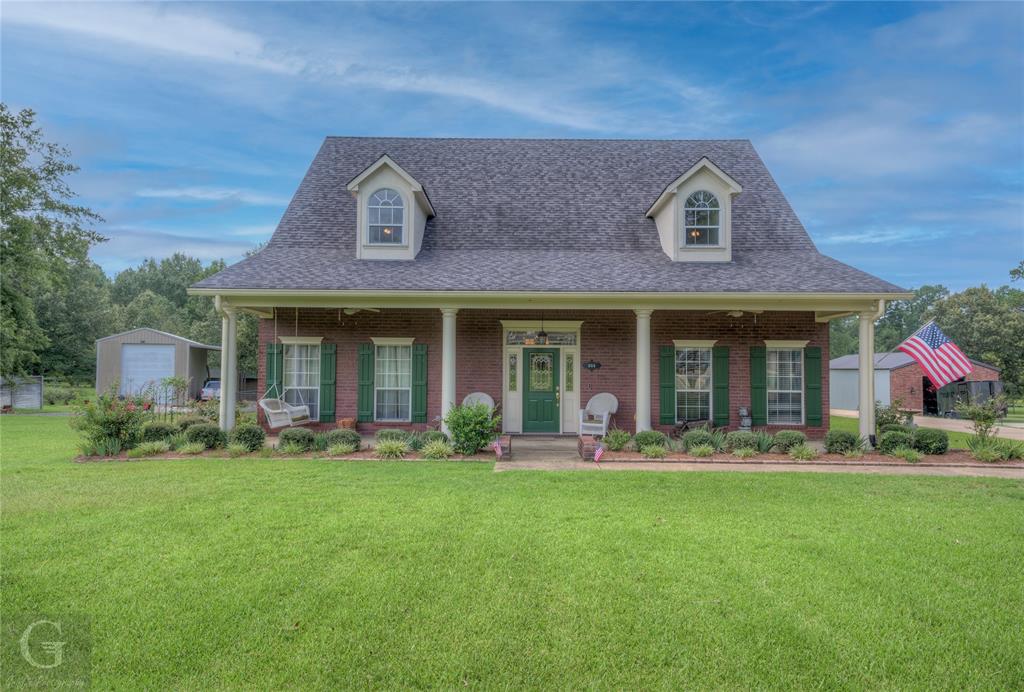 a front view of a house with a garden and porch