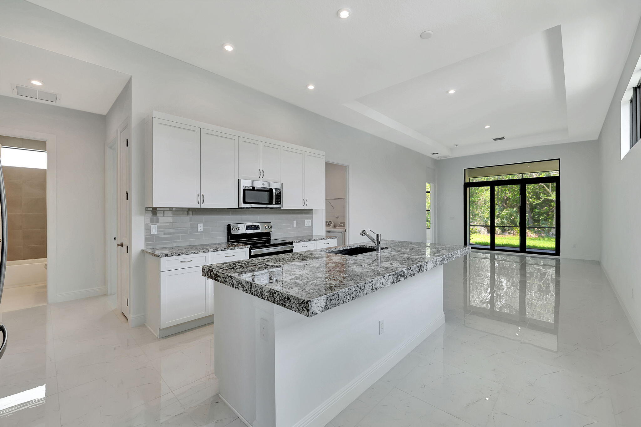 a kitchen with stainless steel appliances granite countertop a stove a sink and a refrigerator