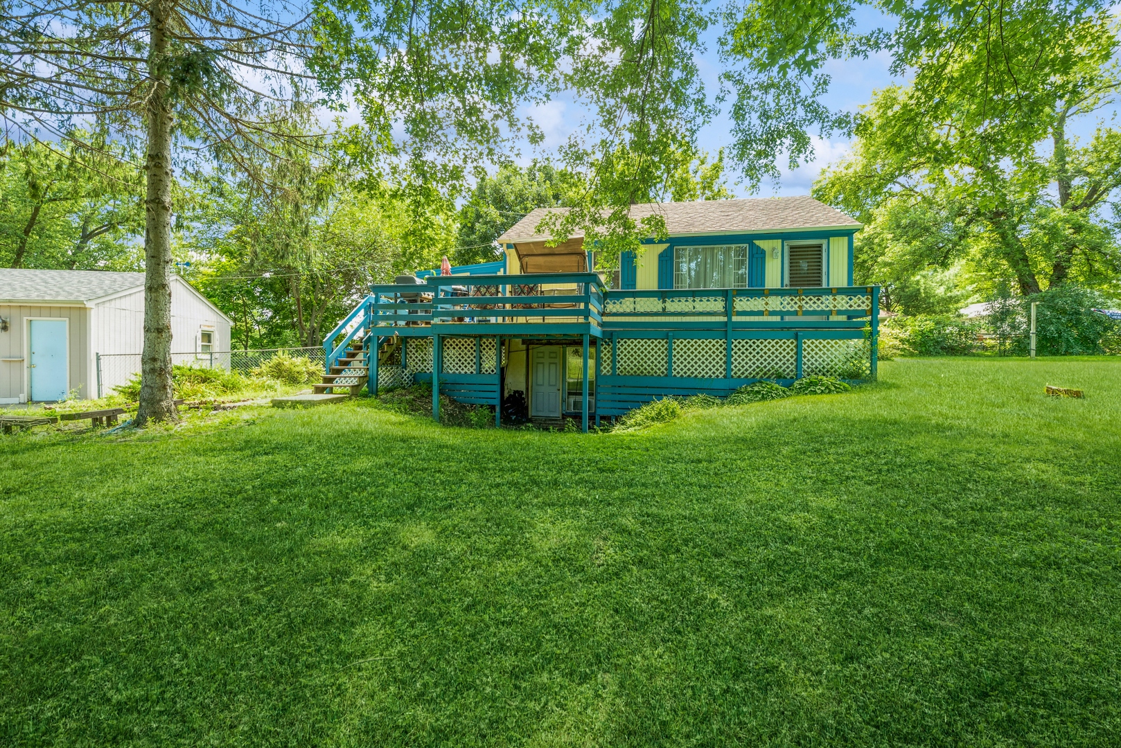 a view of a house with a yard table and chairs