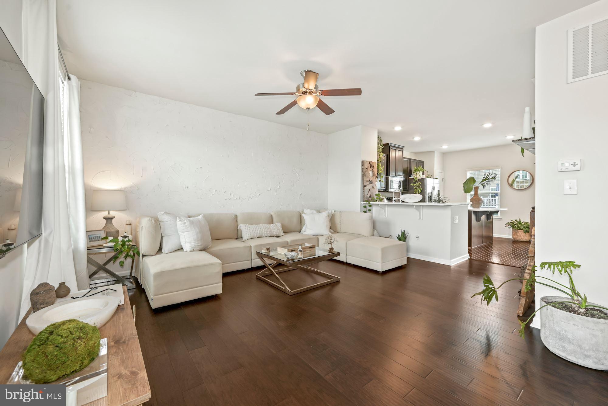 a living room with fireplace furniture and a wooden floor