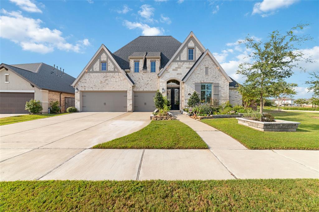 a front view of a house with a yard and garage