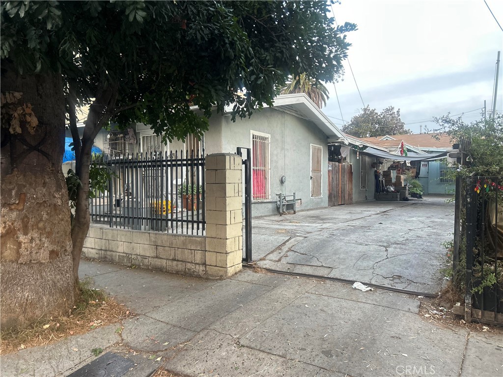 a view of a house with a yard and tree s