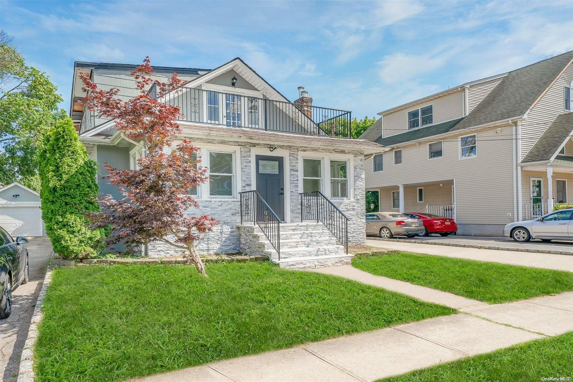 a front view of house with yard and outdoor seating