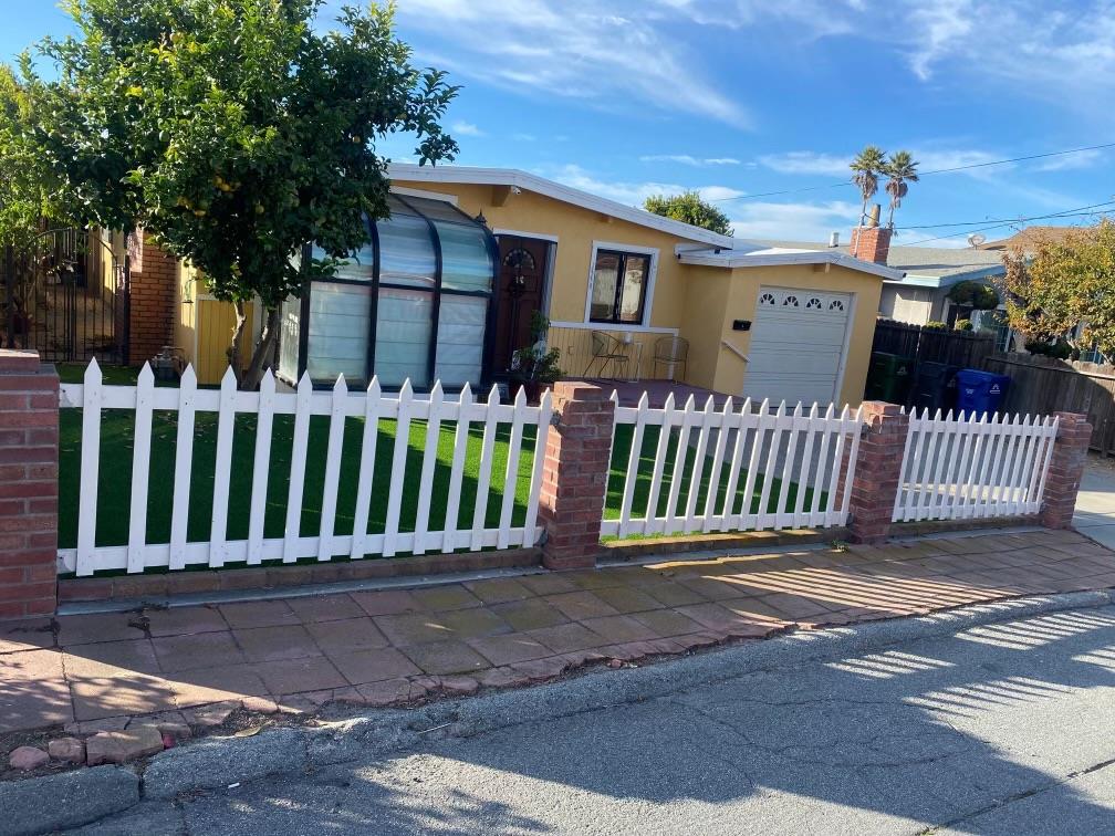 a view of a house with wooden fence