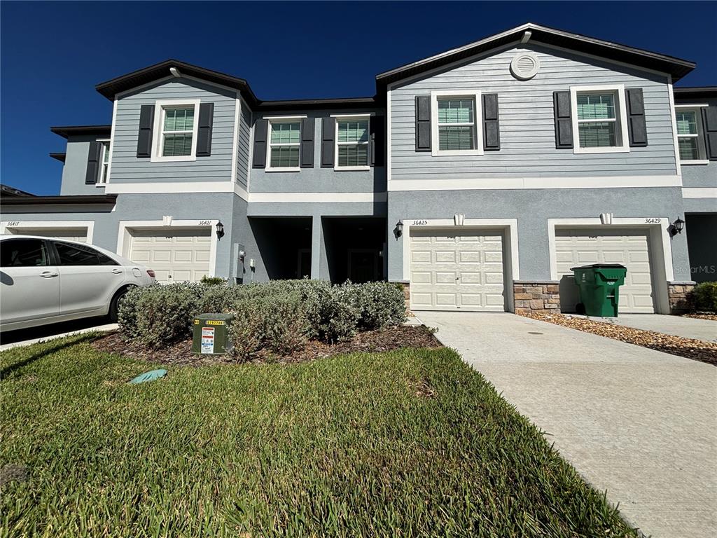 a front view of a house with a yard