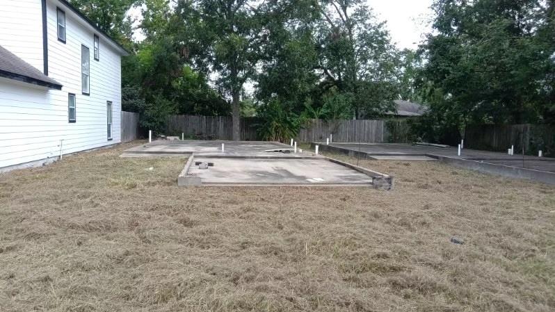 a view of a backyard with large trees