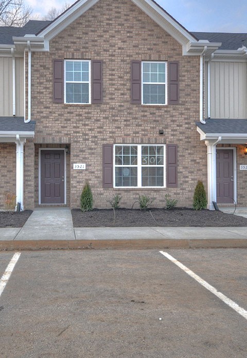 a front view of a house with a yard and a garage