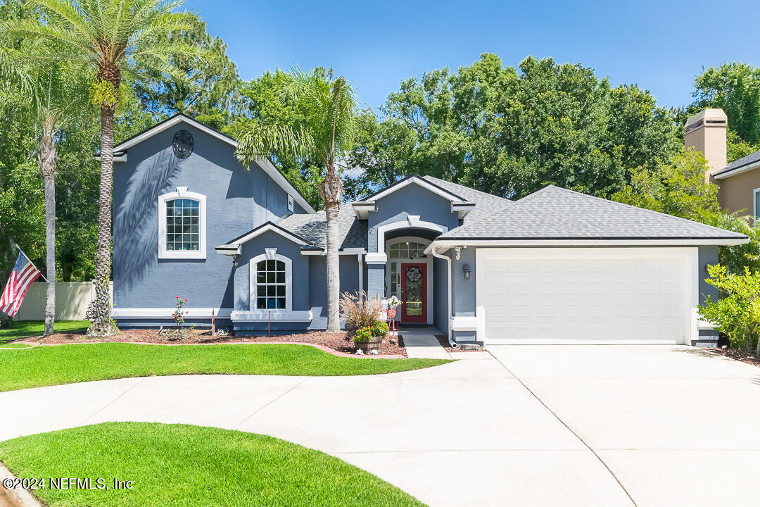 a front view of a house with a yard and garage