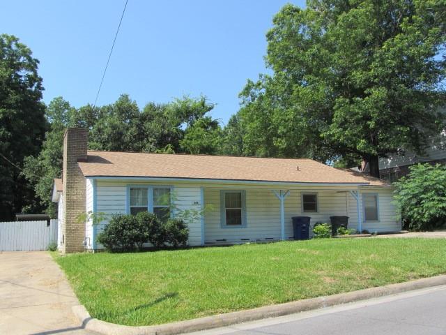 a view of a house with a backyard