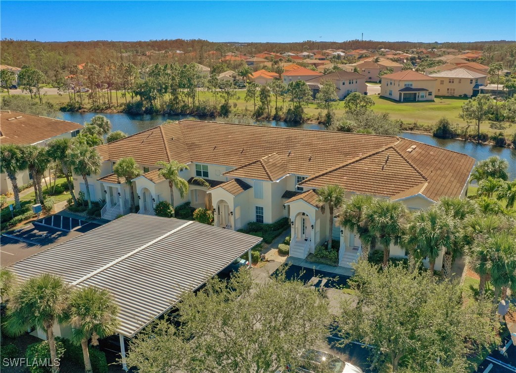 an aerial view of a house with a garden and lake view