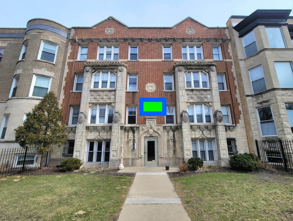 a front view of a residential apartment building with a yard