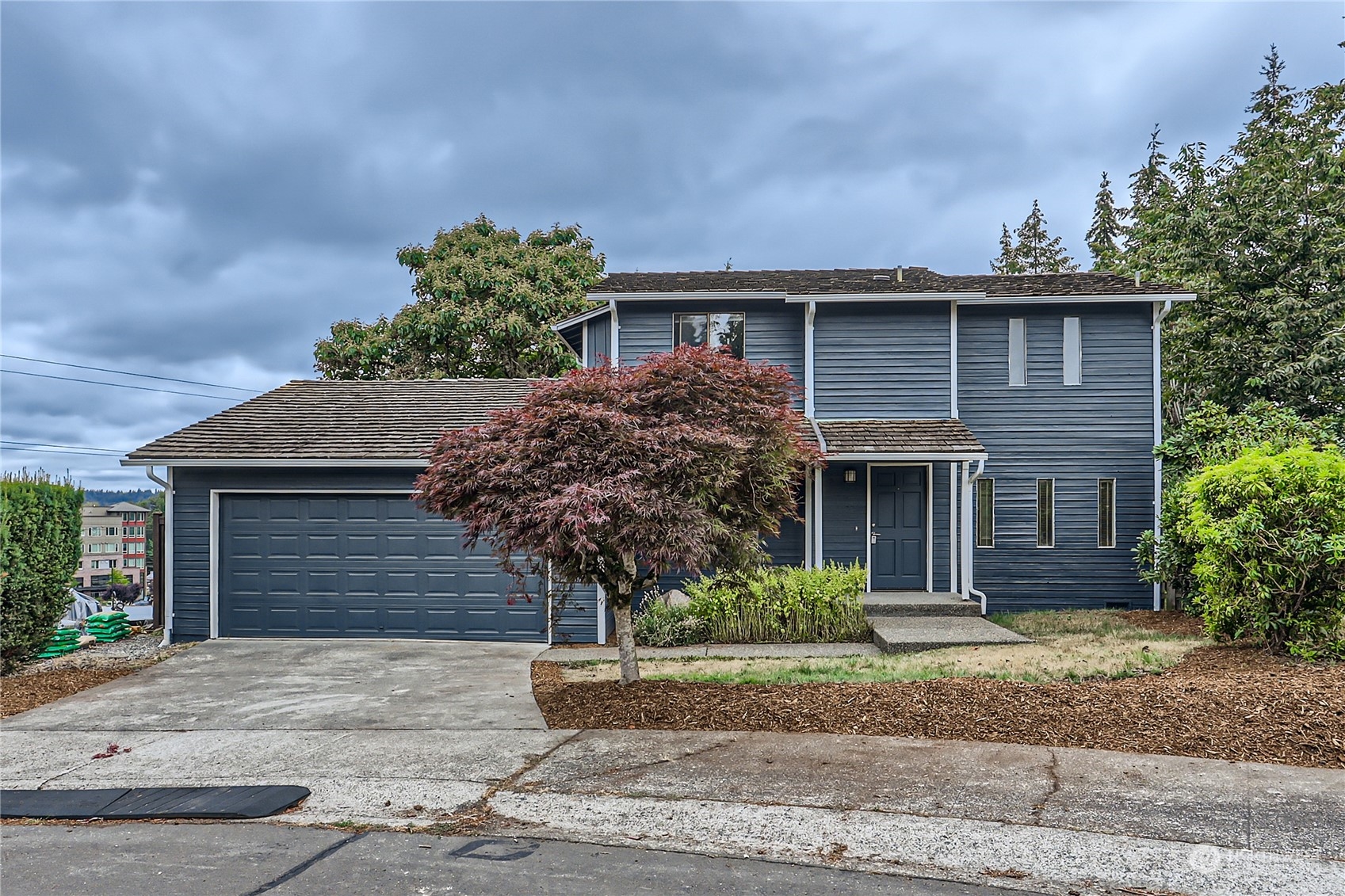 a front view of a house with a yard and garage