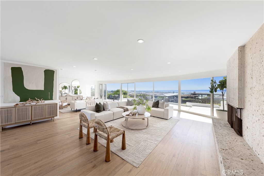 a living room with furniture fireplace and wooden floor