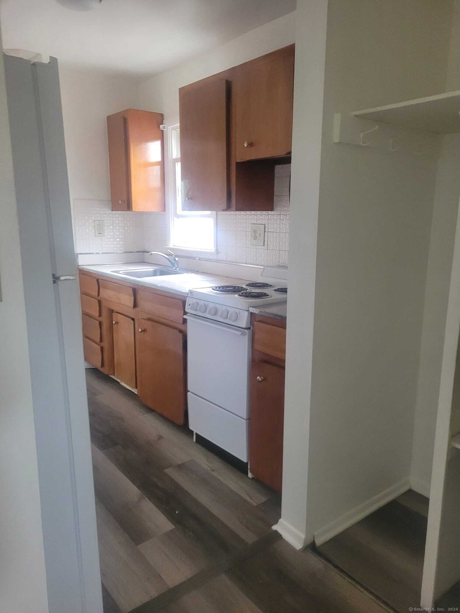 a kitchen with stainless steel appliances granite countertop a sink and a stove top oven