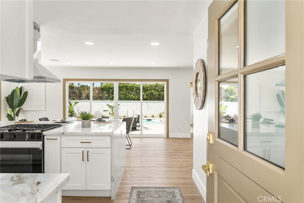 a very nice looking living room with a large window and wooden floor