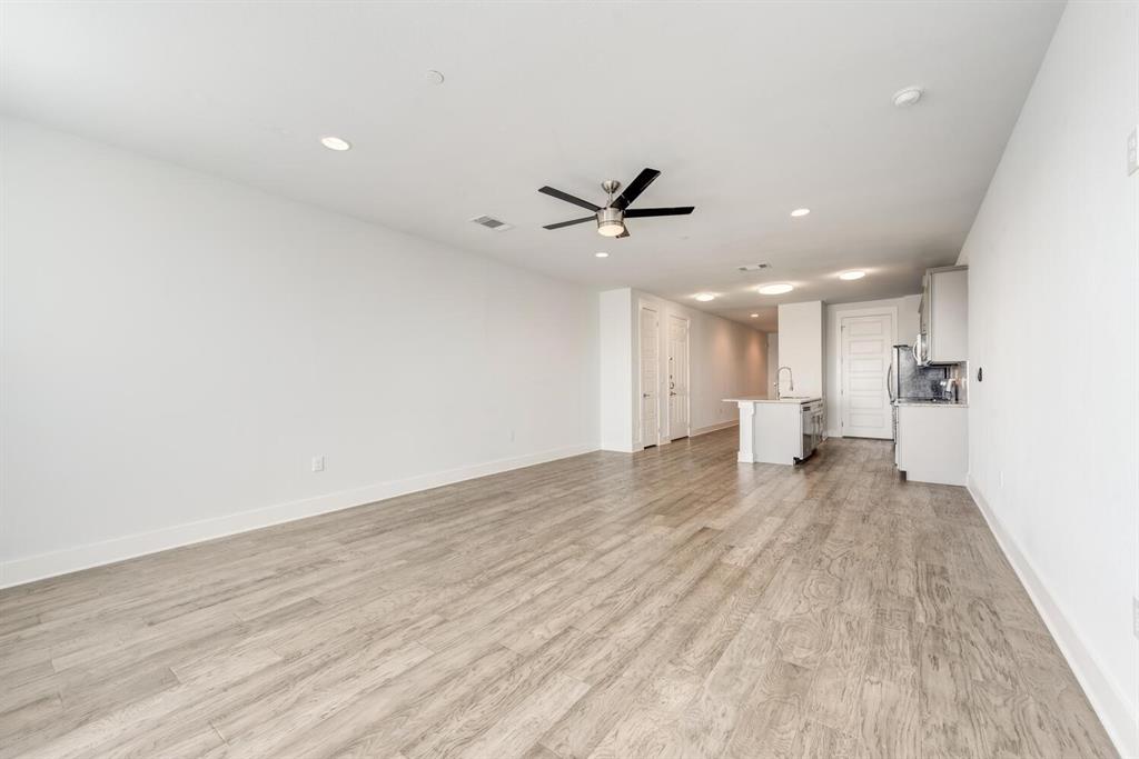 a view of a livingroom with a ceiling fan and wooden floor