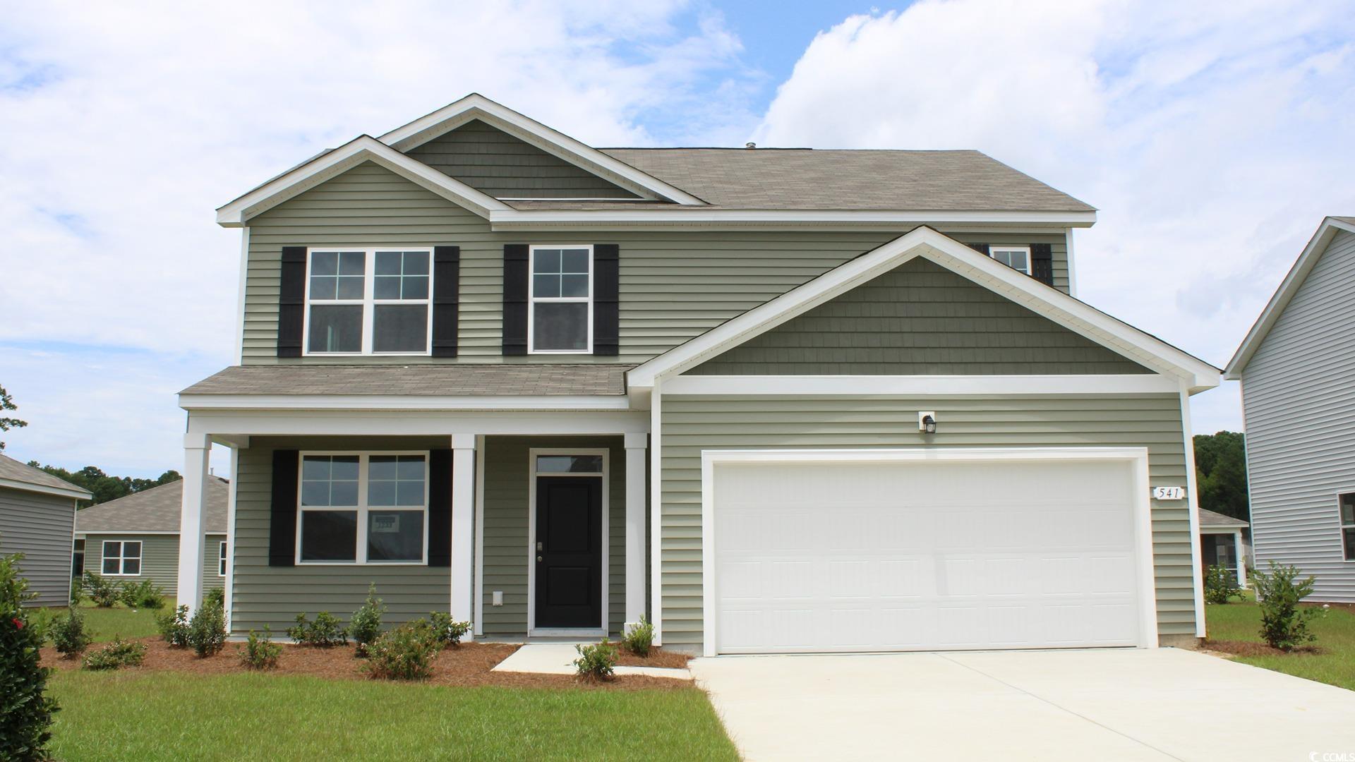 Craftsman house with a front lawn