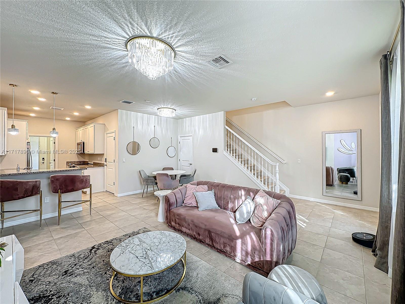 a living room with furniture and a dining table