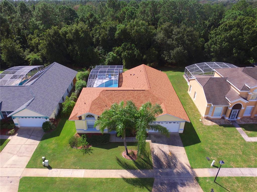 an aerial view of multiple houses with yard