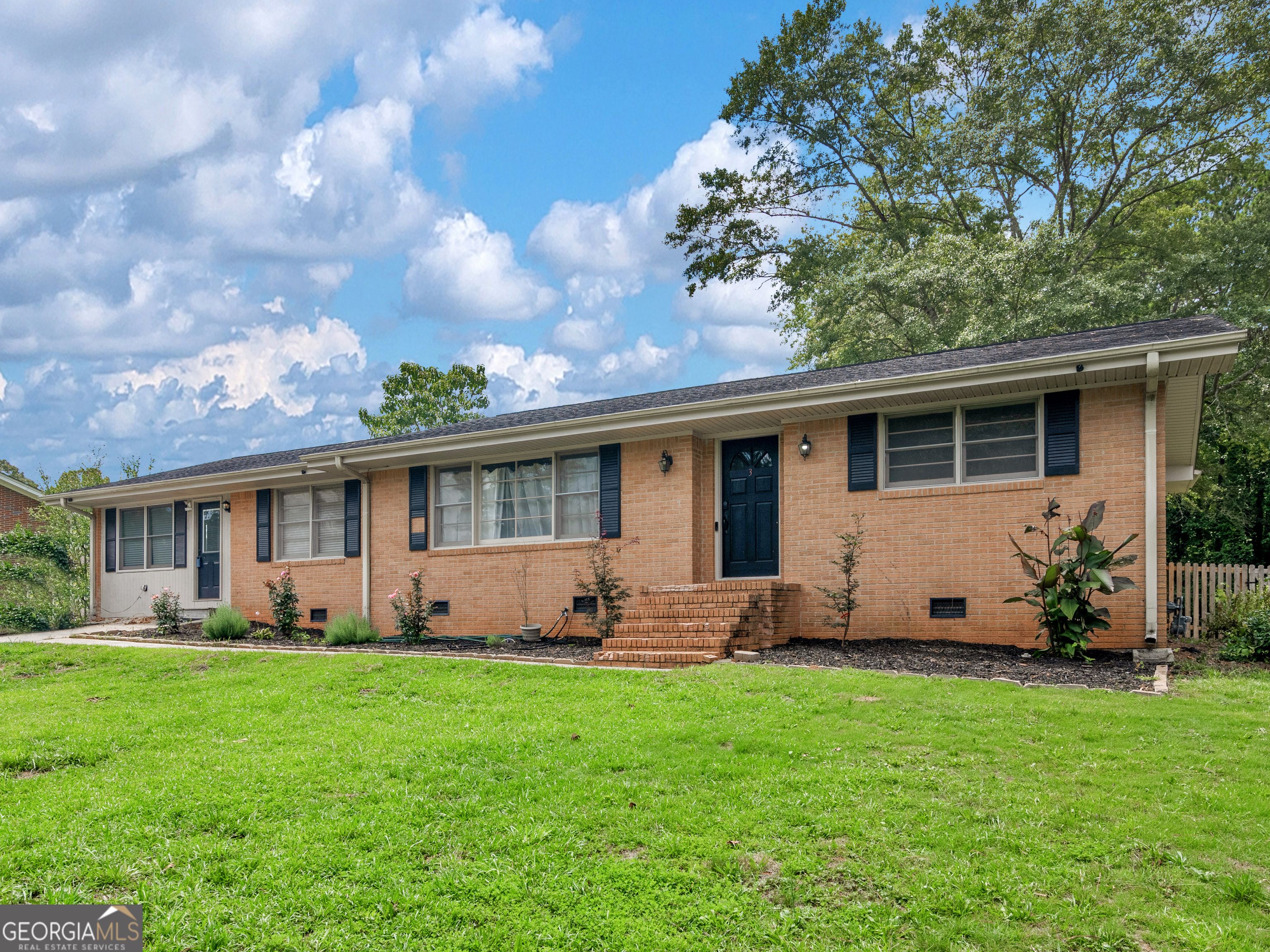 a front view of house with yard and green space