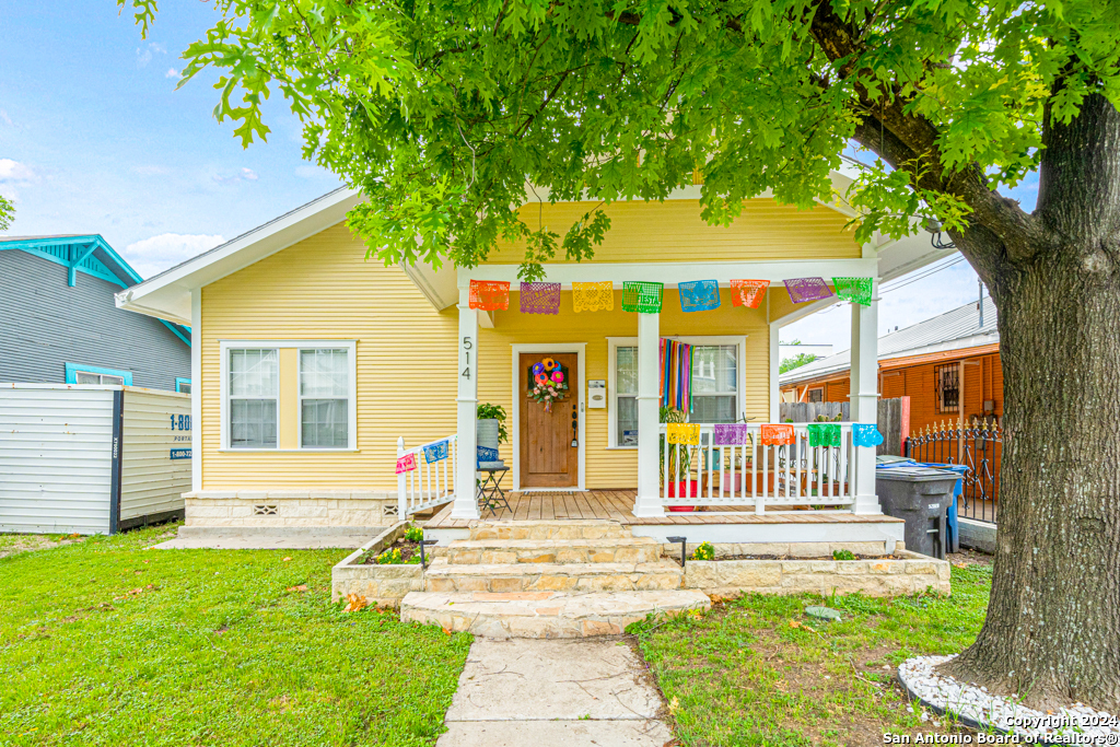 a front view of a house with a yard table and chairs