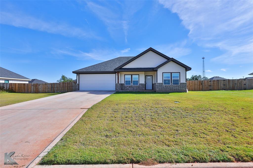 a house with huge green field in front of it