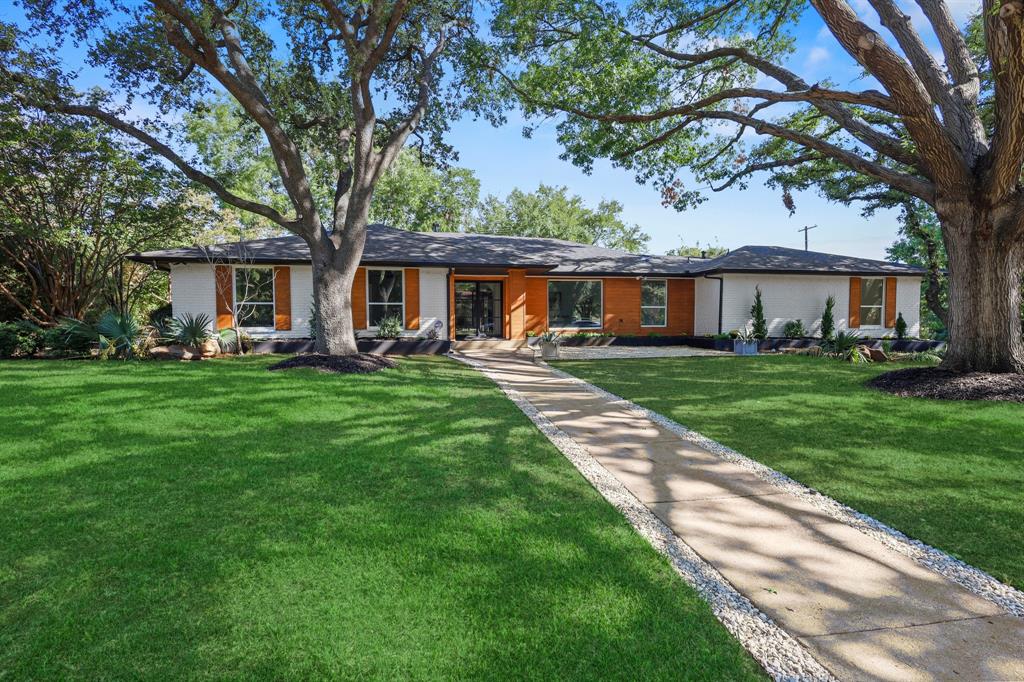 a front view of house with yard and green space