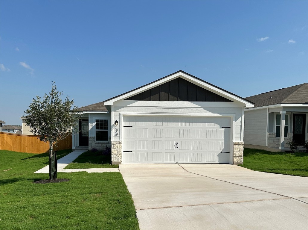 a front view of house with a garden