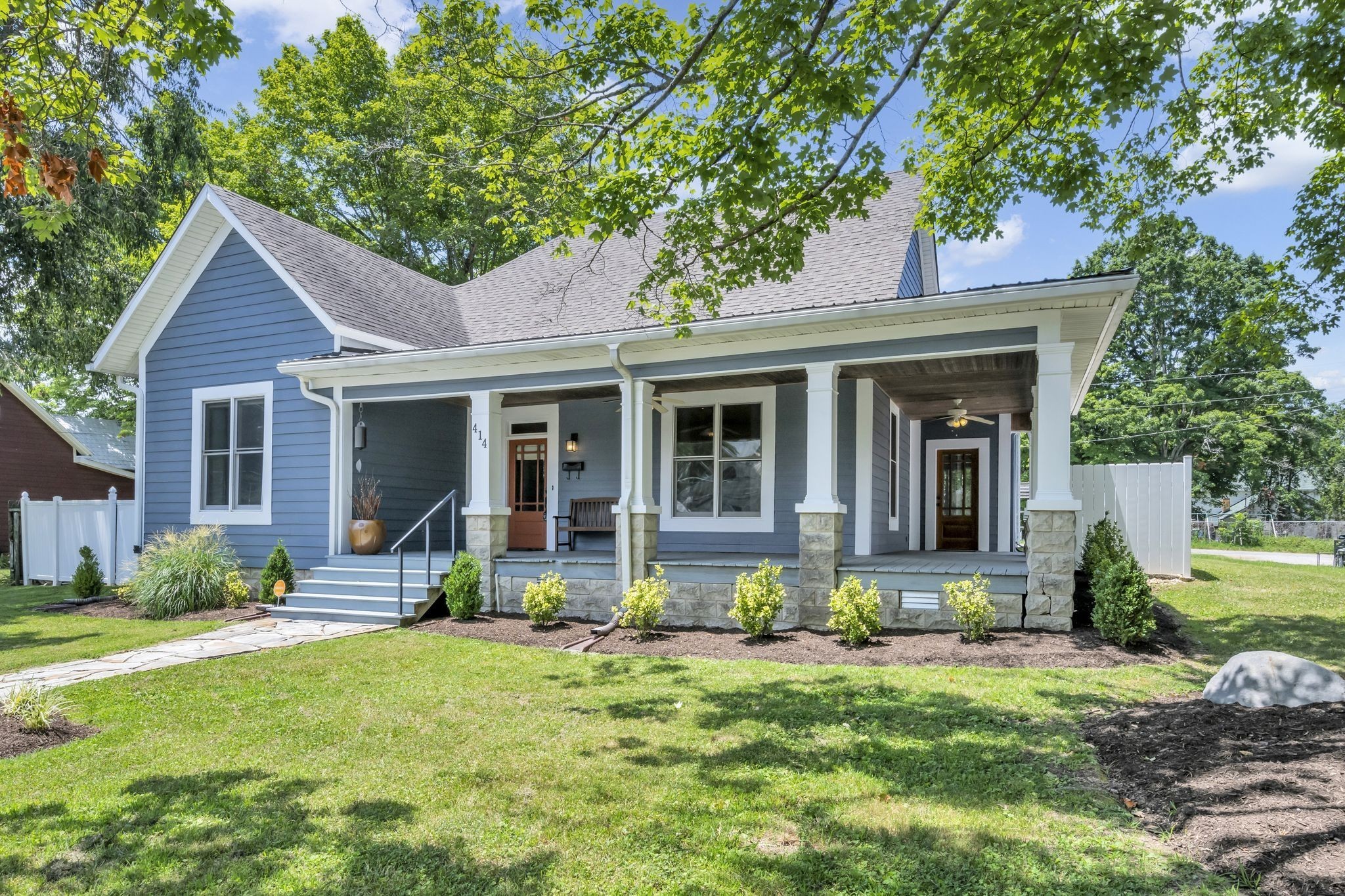 a front view of a house with garden and porch