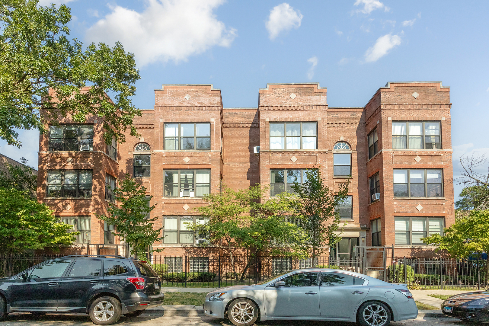 a view of cars parked in front of a building