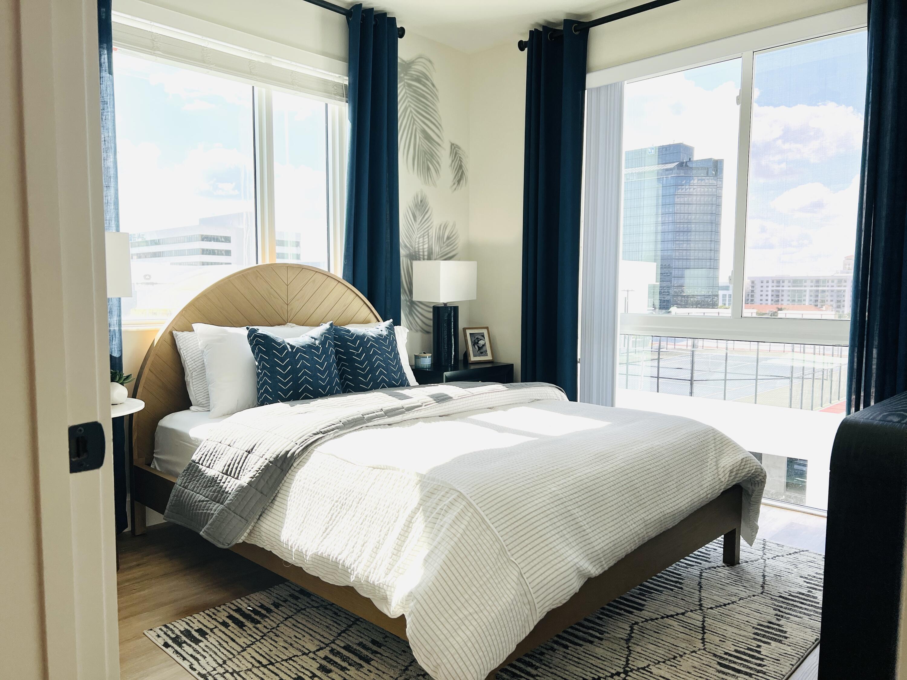 a bedroom with a large bed and a large window