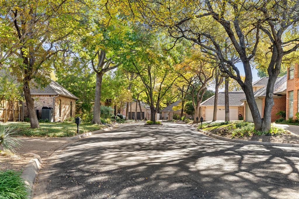 a brick house with trees in front of it