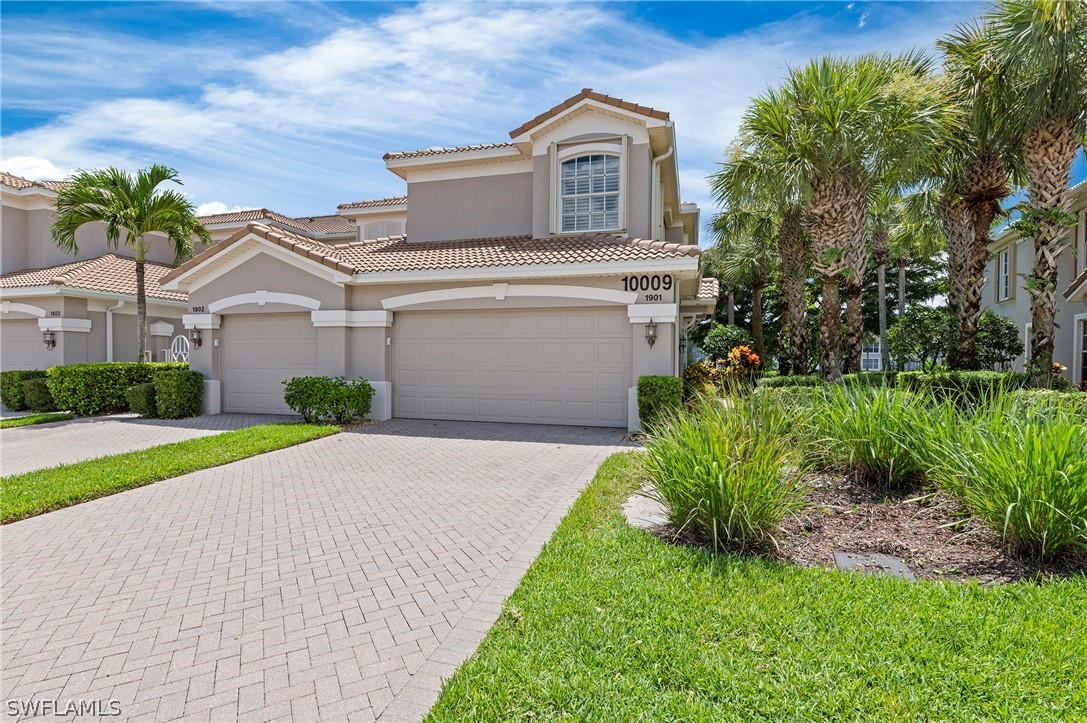 a front view of a house with a yard and garage