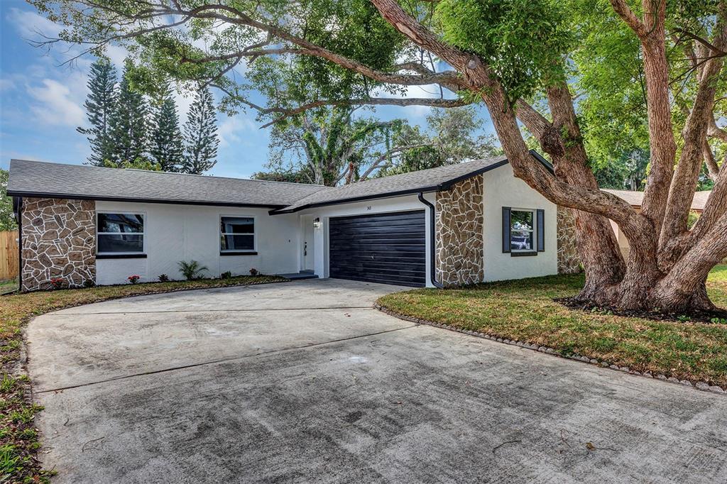 a view of a house with a yard and garage