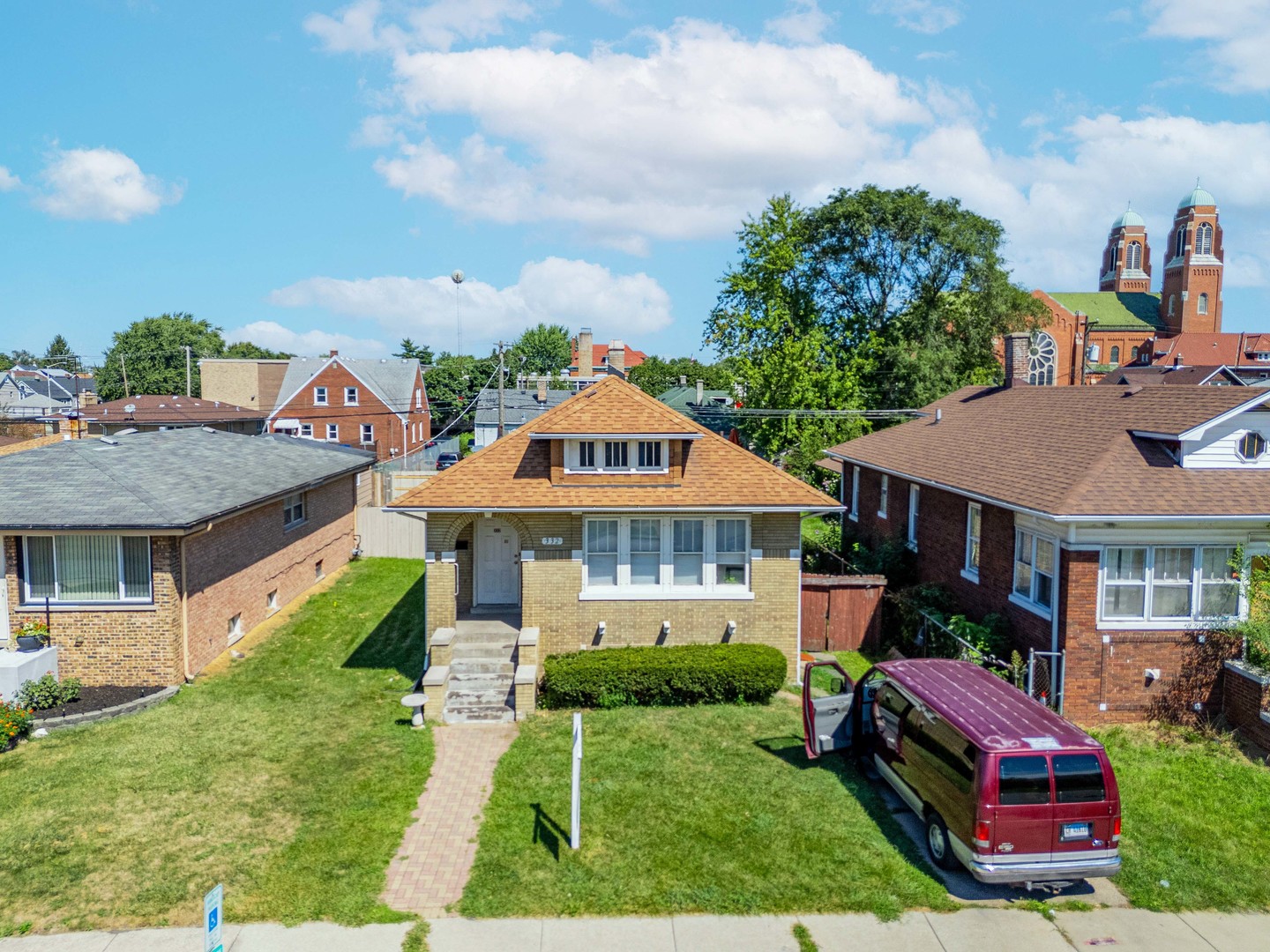 a aerial view of a house with a yard deck and furniture