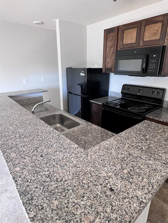 a kitchen with a sink stove and refrigerator