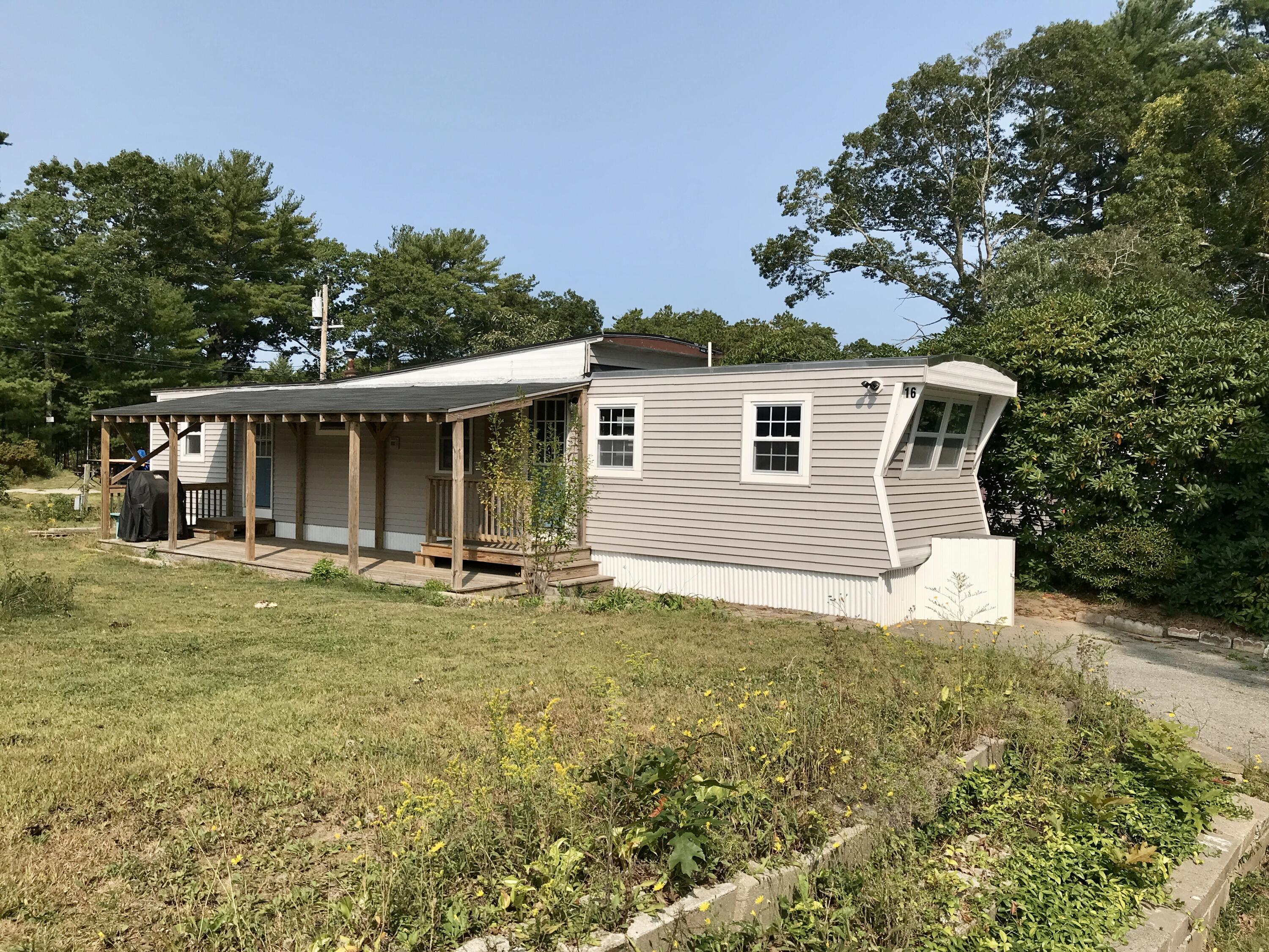 a front view of a house with a garden and porch