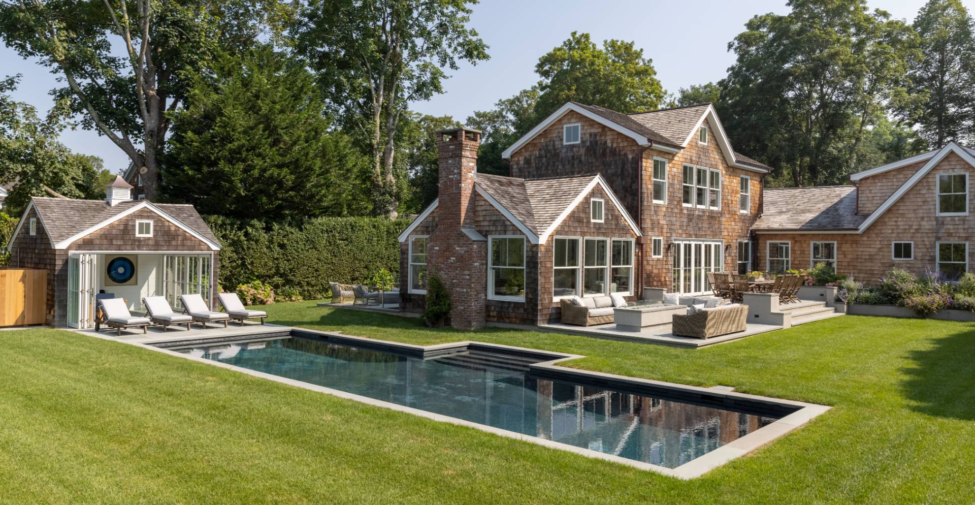 a view of house with yard and swimming pool